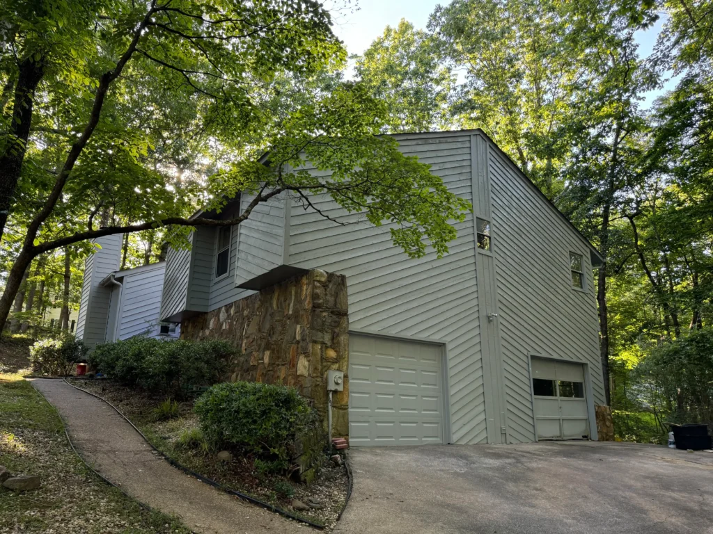 Exterior painting in progress on a multi-story property by Gutter Bro crew