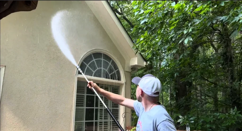 High-powered commercial pressure washing service deep cleaning a business exterior