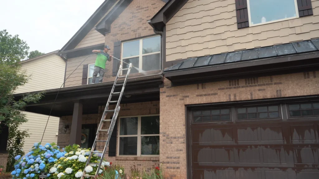 Professional pressure washing service cleaning vinyl siding on a residential home